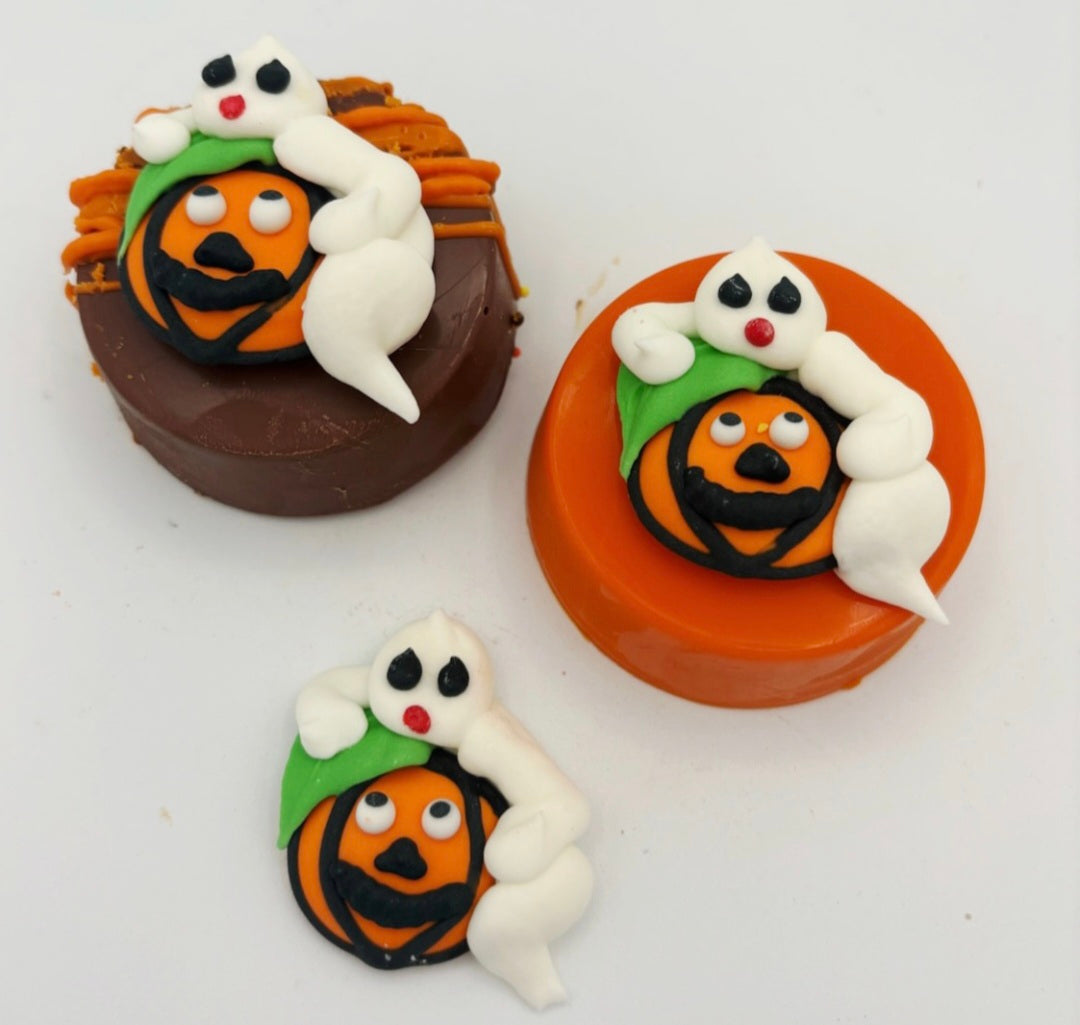 Halloween-themed treats with ghost and pumpkin decorations on a white background